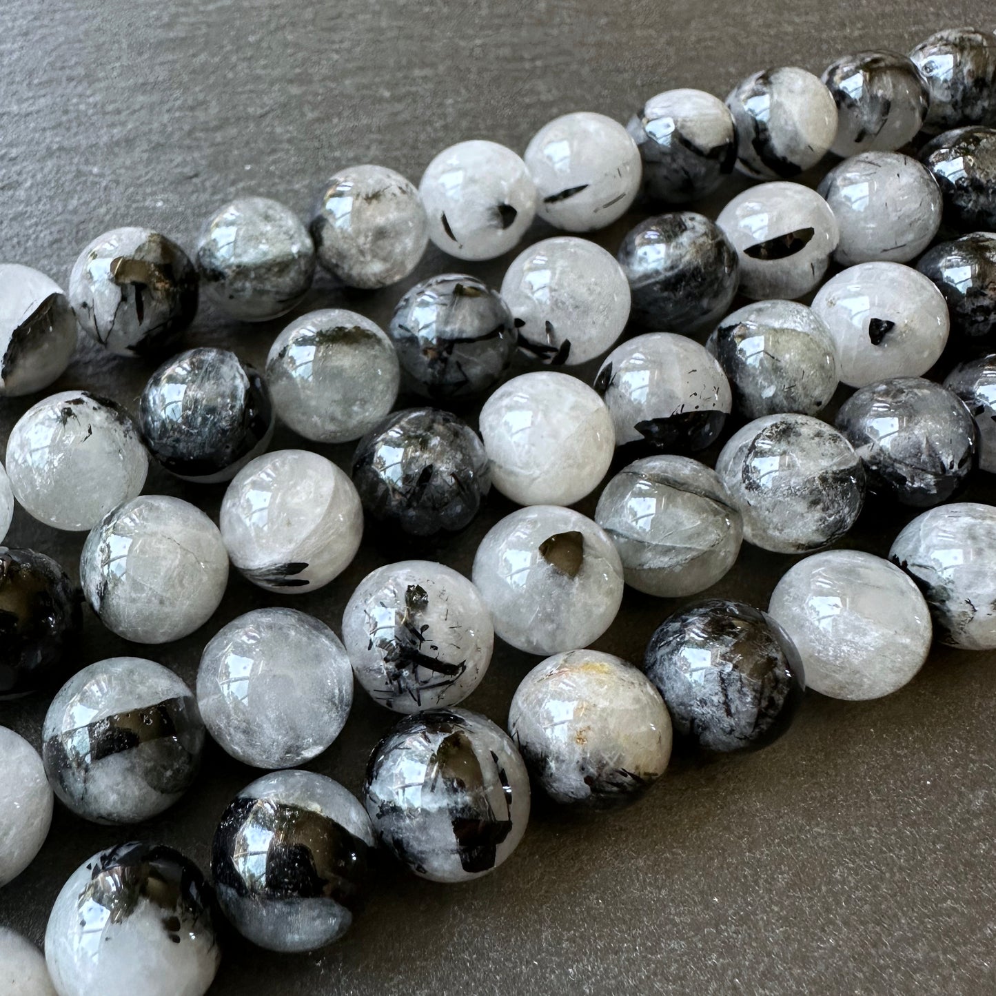 10mm black tourmalinated beads (undyed)- round - smooth - 15" strand - approx. 35 beads