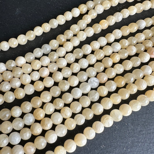 6mm yellow jade beads (undyed) - round- smooth - 15" strand - approx. 65 beads