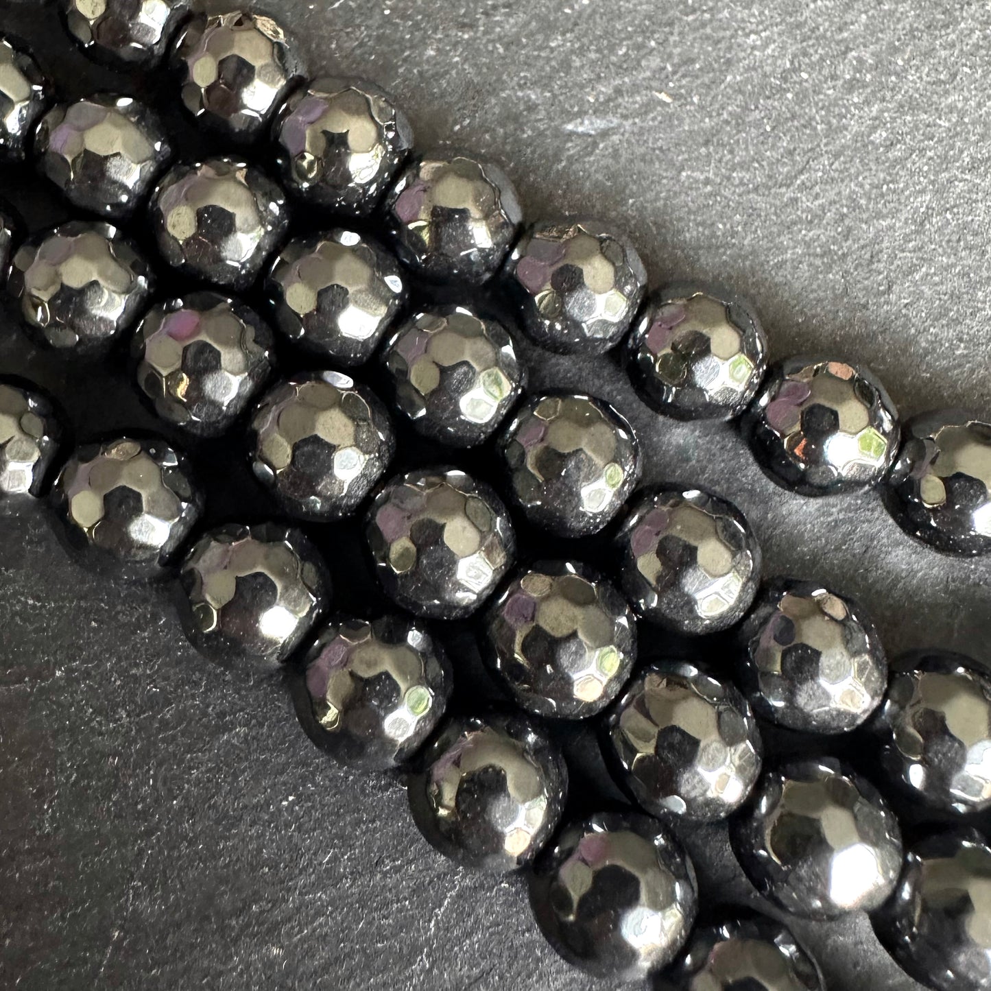 8mm black electroplated hematite - round - faceted - 16" strand - approx. 50 beads