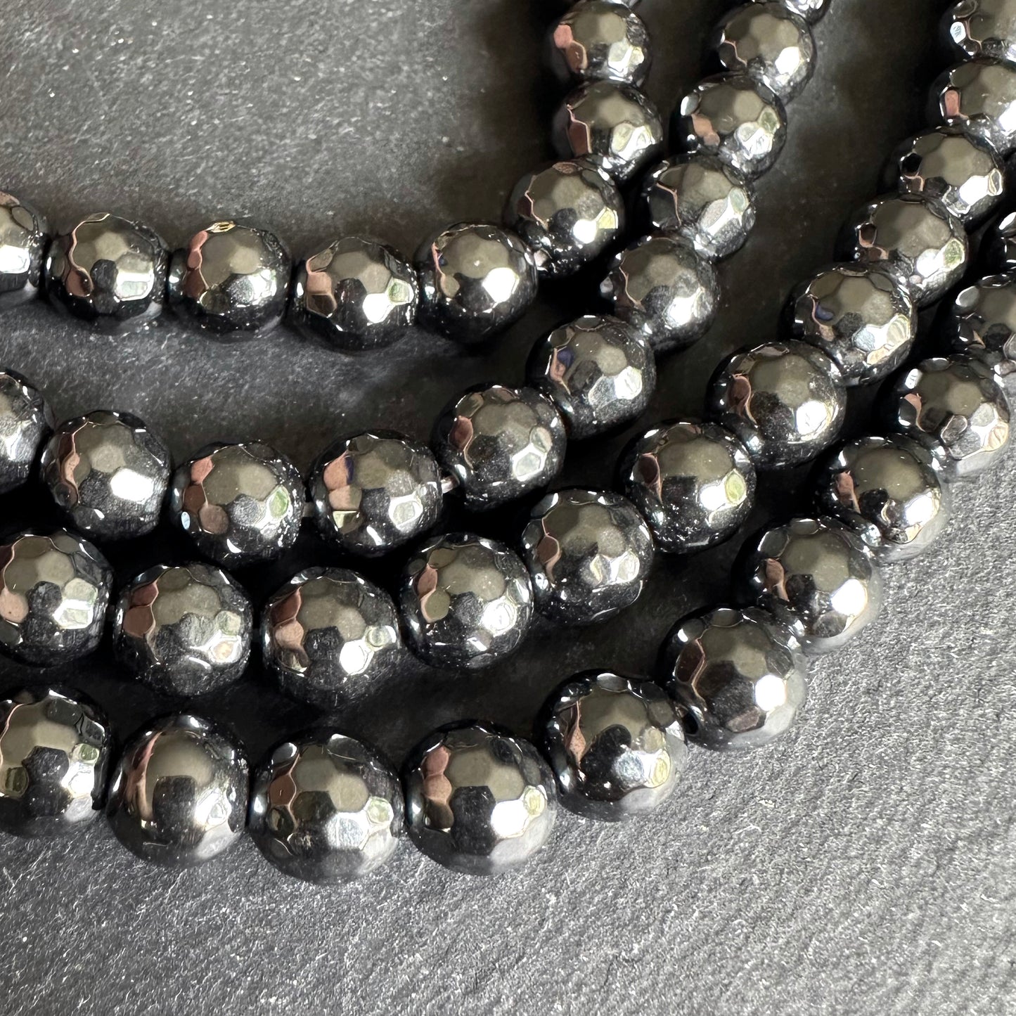 8mm black electroplated hematite - round - faceted - 16" strand - approx. 50 beads