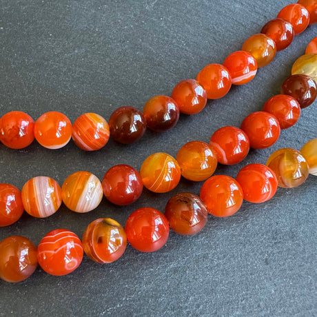 10mm orange striped agate beads - round - smooth - 15" strand - approx. 35 beads