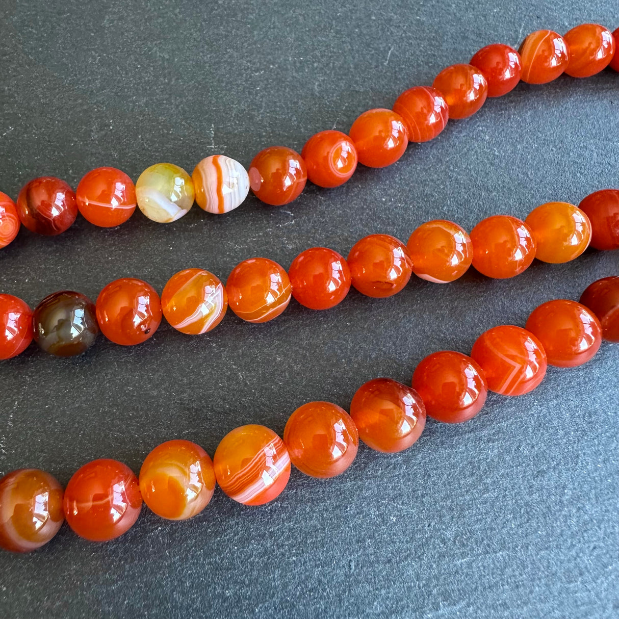 10mm orange striped agate beads - round - smooth - 15" strand - approx. 35 beads