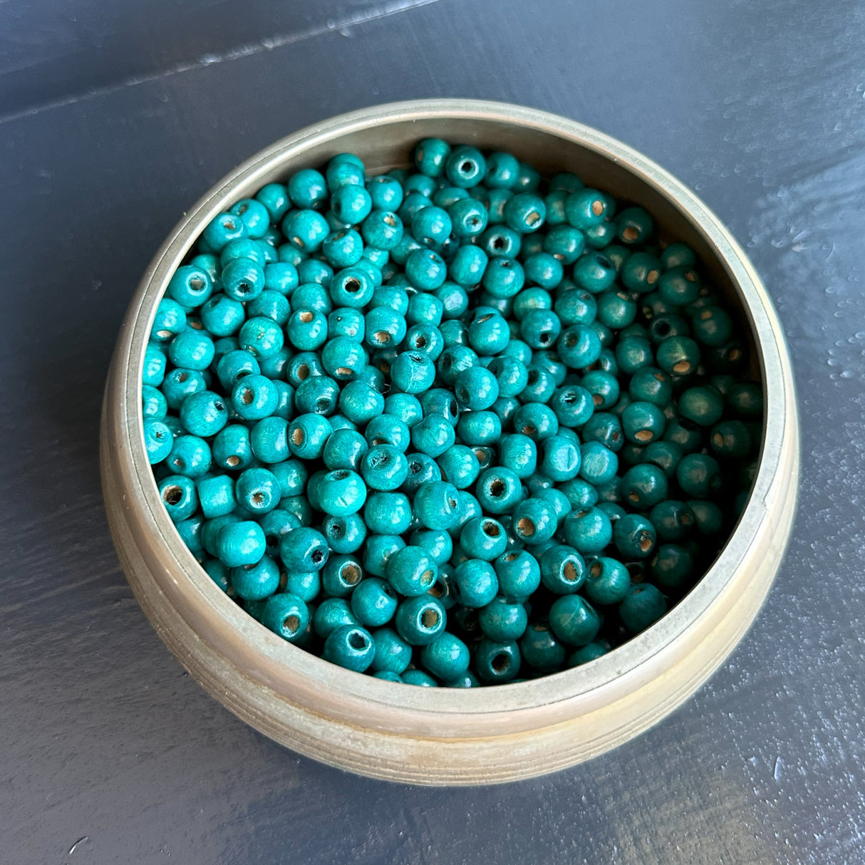 bowl of blue wood beads for jewelry making