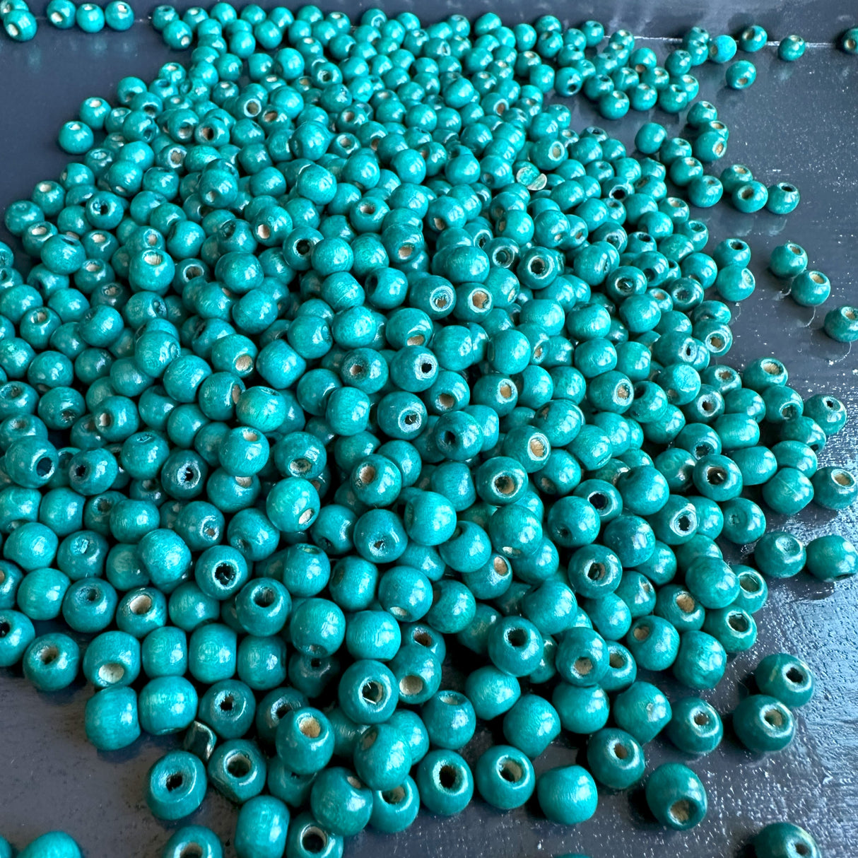 pile of blue wood bead supply for jewelry making