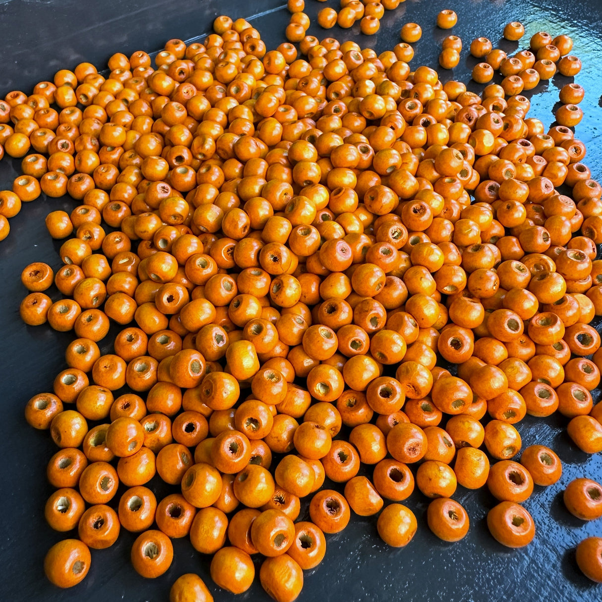 pile of orange wood beads for jewelry making