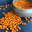 bowl of orange woods bead for bracelet diy