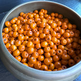 orange wood beads in bowl for jewelry making