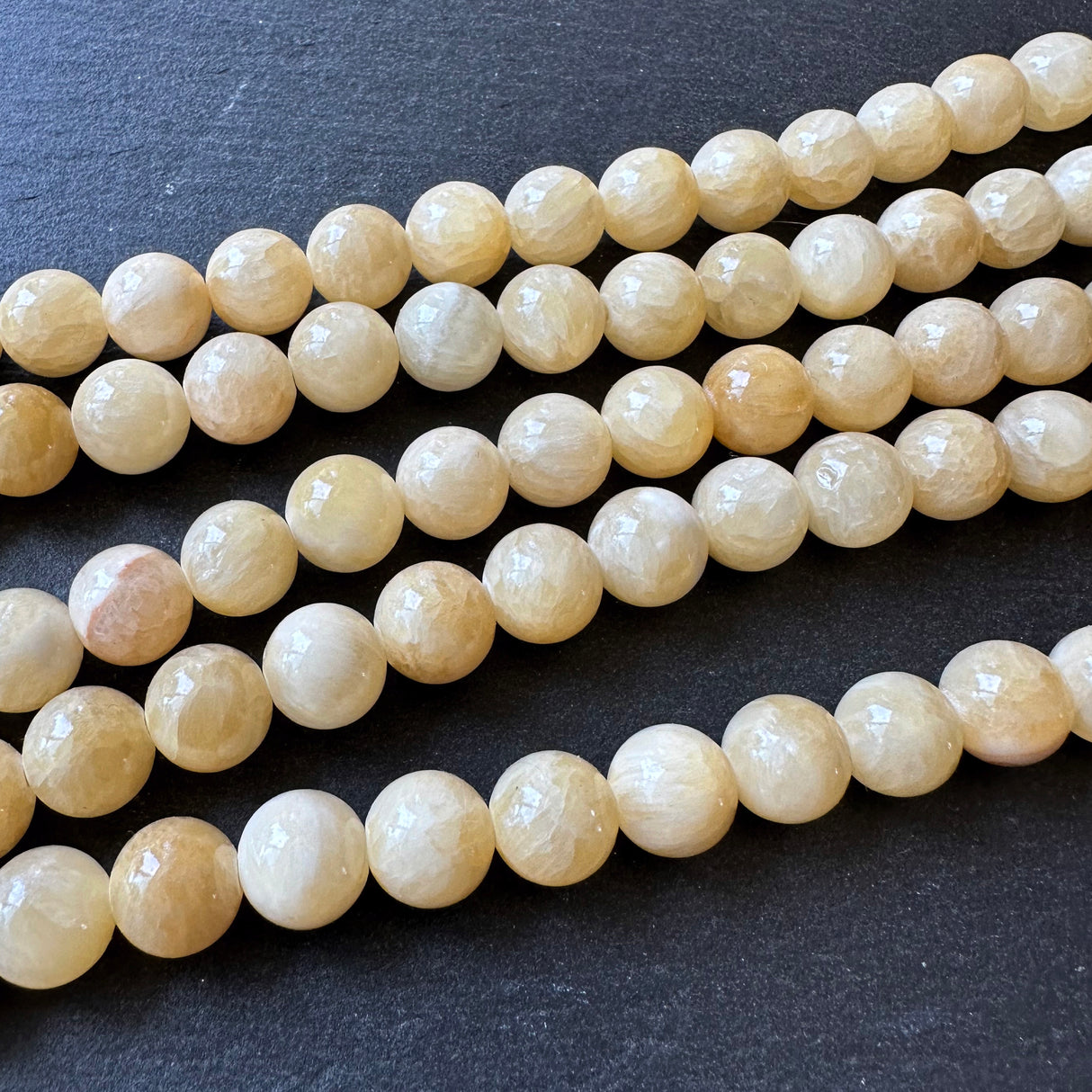 10mm yellow jade beads (undyed) - round - smooth - 16" strand - approx. 35 beads