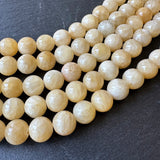 10mm yellow jade beads (undyed) - round - smooth - 16" strand - approx. 35 beads