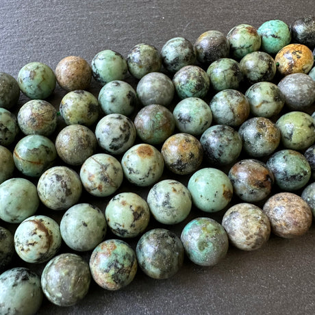 10mm african turquoise beads (undyed) - round - smooth - 15" strand - approx. 35 beads