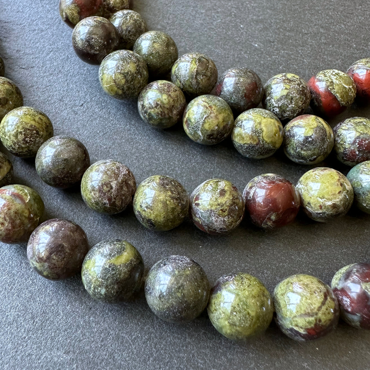 10mm dragon blood jasper beads - round - smooth - 15" strand - approx. 35 beads