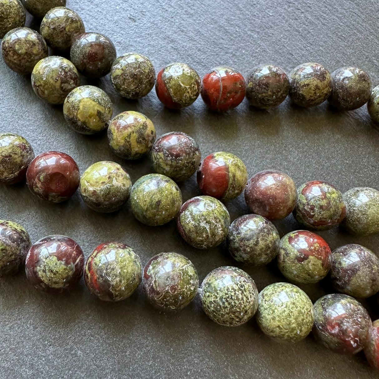 10mm dragon blood jasper beads - round - smooth - 15" strand - approx. 35 beads