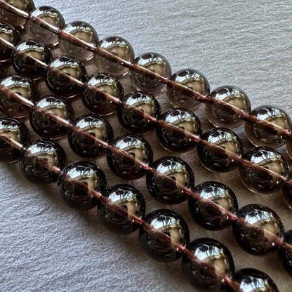 10mm smoky quartz beads (undyed) - round - smooth - 15" strand - approx. 35 beads