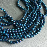 4mm blue electroplated hematite beads - round - faceted - 15" strand - approx. 100 beads