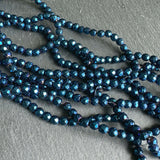 4mm blue electroplated hematite beads - round - faceted - 15" strand - approx. 100 beads