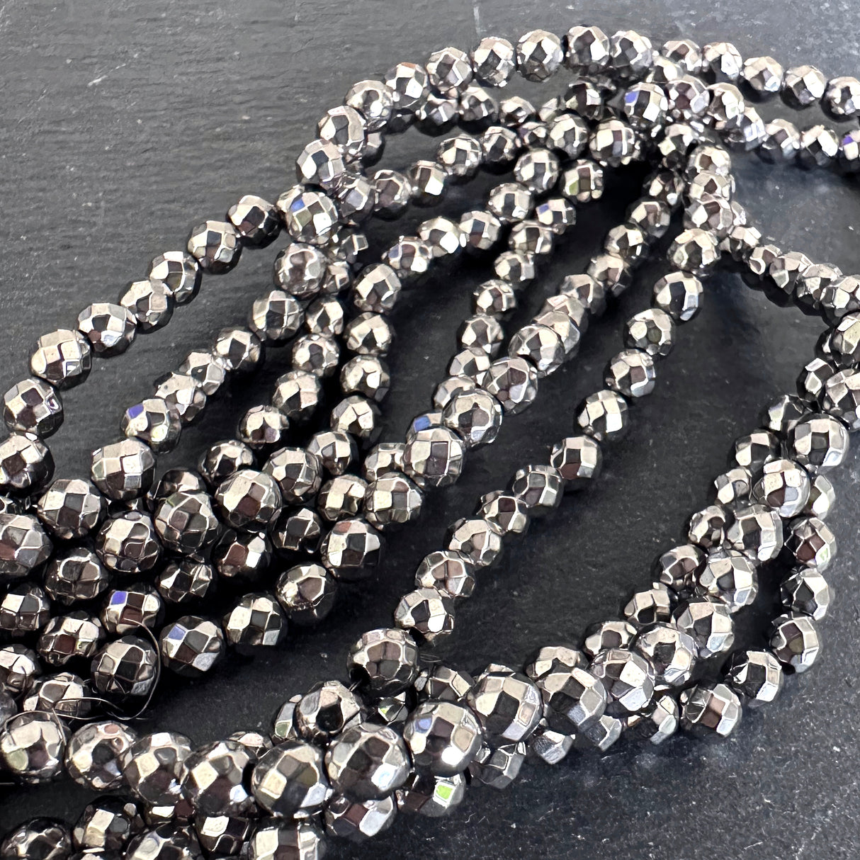 4mm silver electroplated hematite - round - faceted - 15" strand - approx. 100 beads