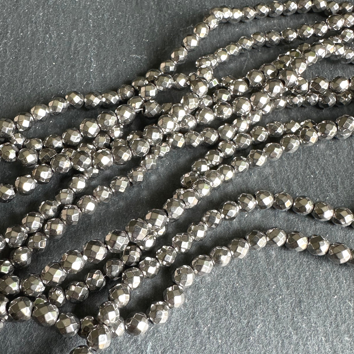 4mm silver electroplated hematite - round - faceted - 15" strand - approx. 100 beads