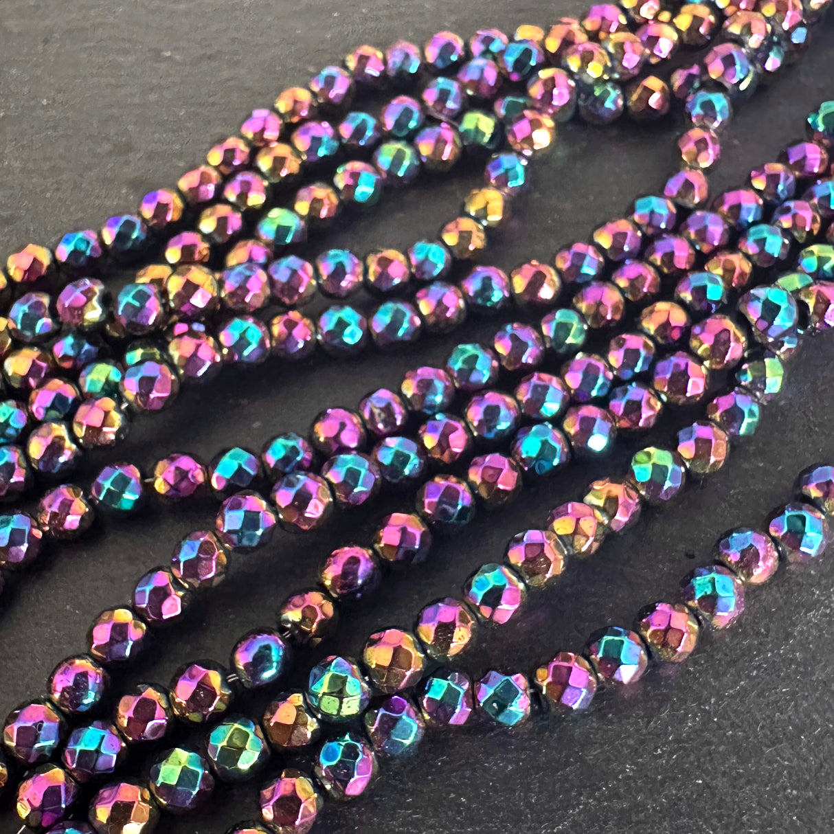 4mm rainbow electroplated hematite - round - faceted - 15" strand - approx. 100 beads