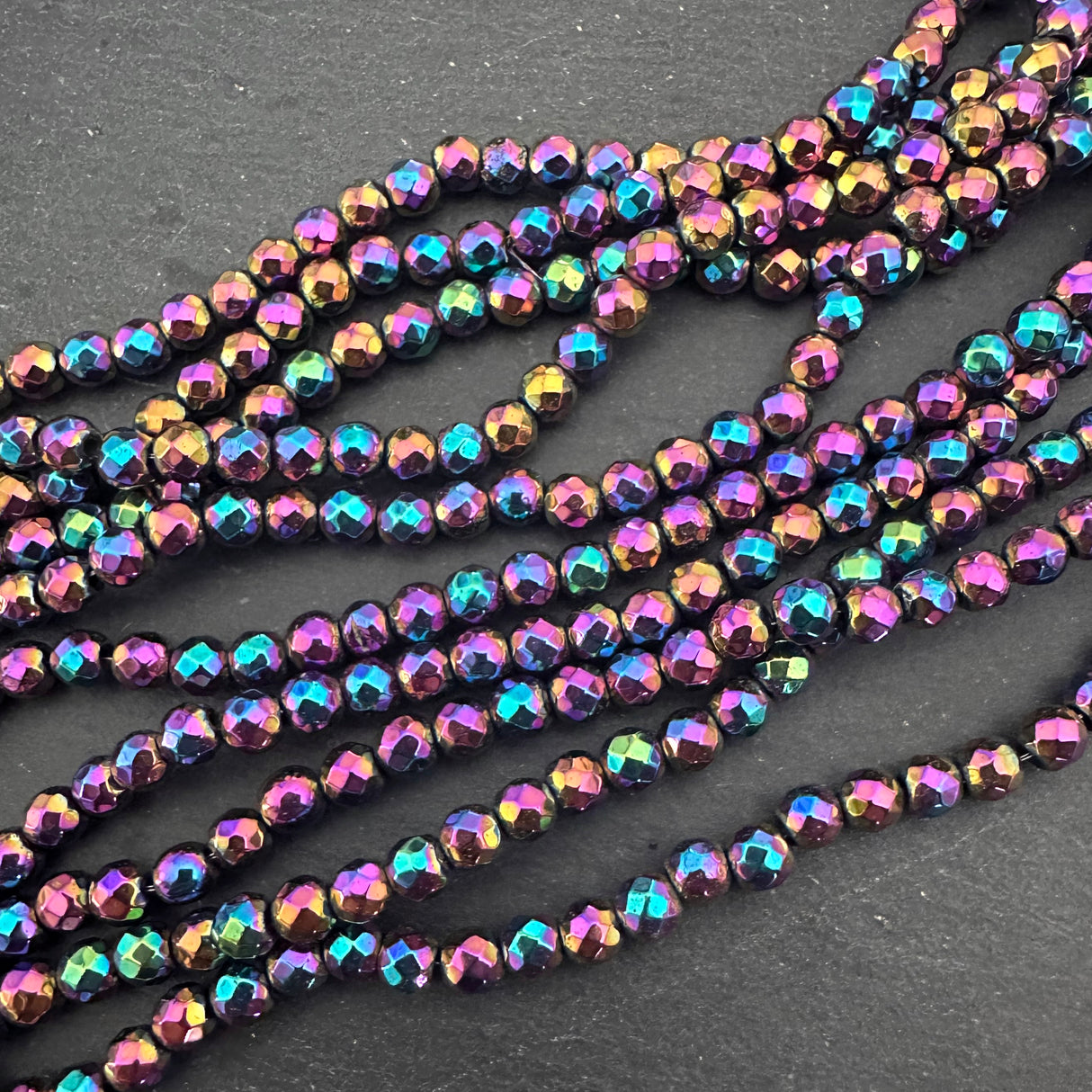 4mm rainbow electroplated hematite - round - faceted - 15" strand - approx. 100 beads