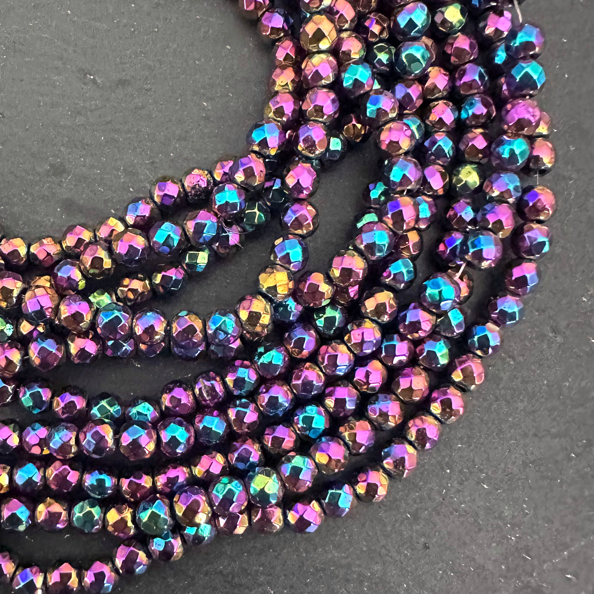 4mm rainbow electroplated hematite - round - faceted - 15" strand - approx. 100 beads