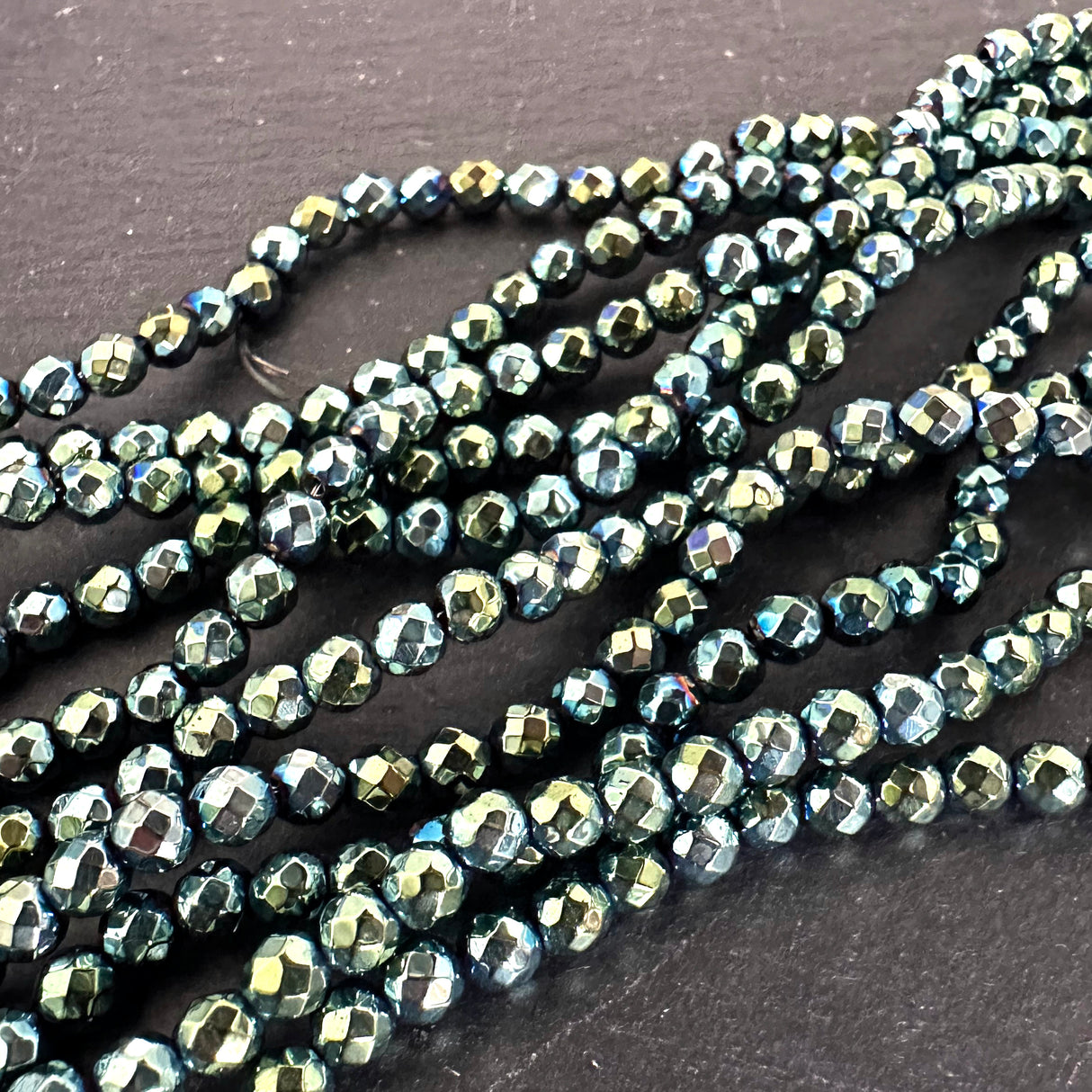 4mm green electroplated hematite beads - round - faceted - 15" strand - approx. 100 beads