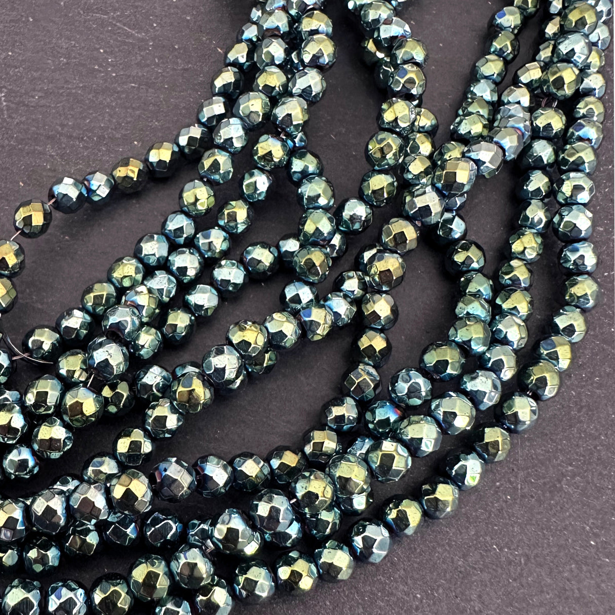 4mm green electroplated hematite beads - round - faceted - 15" strand - approx. 100 beads