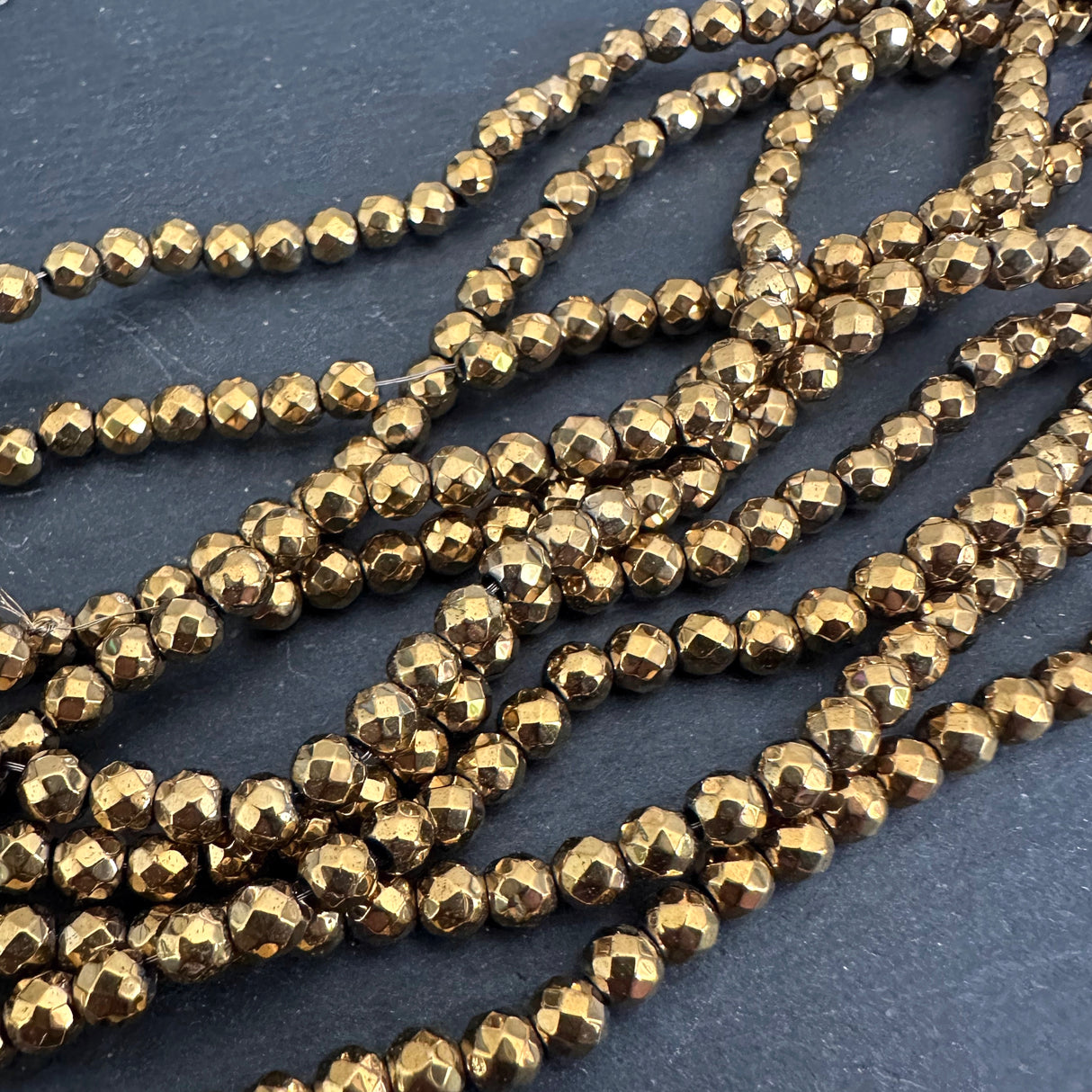 4mm gold electroplated hematite beads - round - faceted - 15" strand - approx. 100 beads