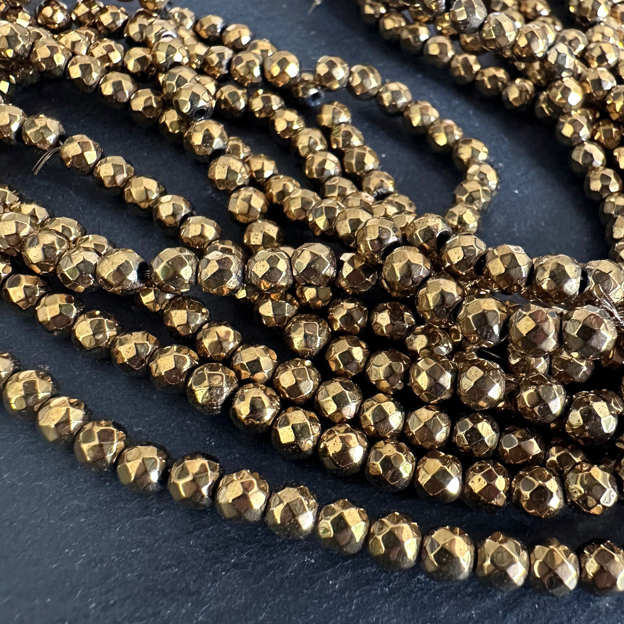 4mm gold electroplated hematite beads - round - faceted - 15" strand - approx. 100 beads