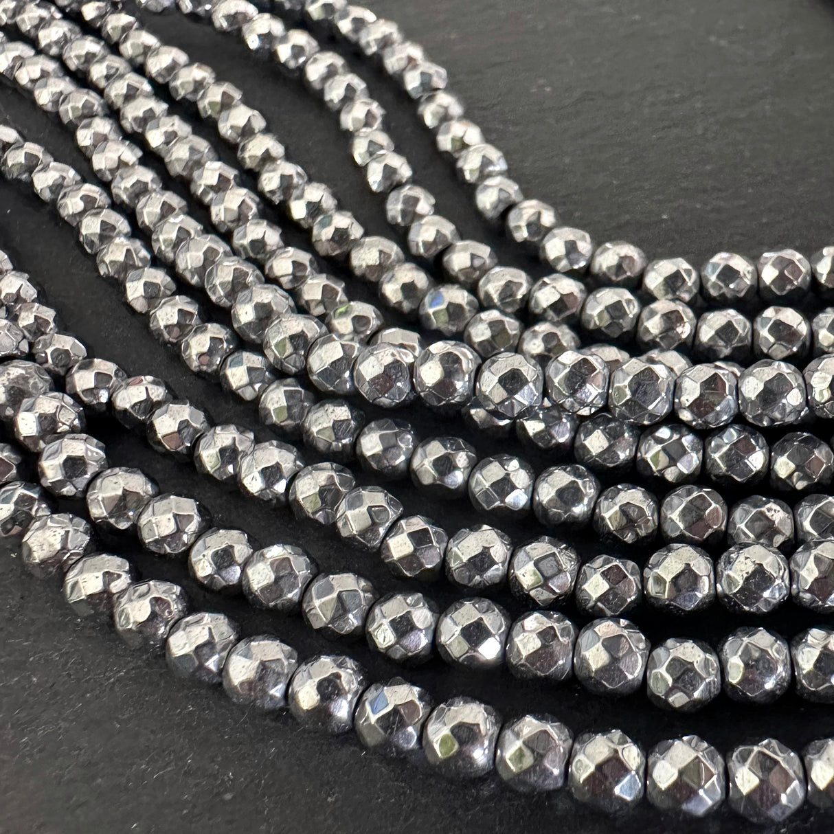 4mm platinum silver electroplated hematite beads - round - faceted - 15" strand - approx. 100 beads