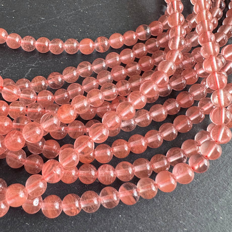 6mm cherry quartz beads (glass) - round - smooth - 15" strand - approx. 65 beads