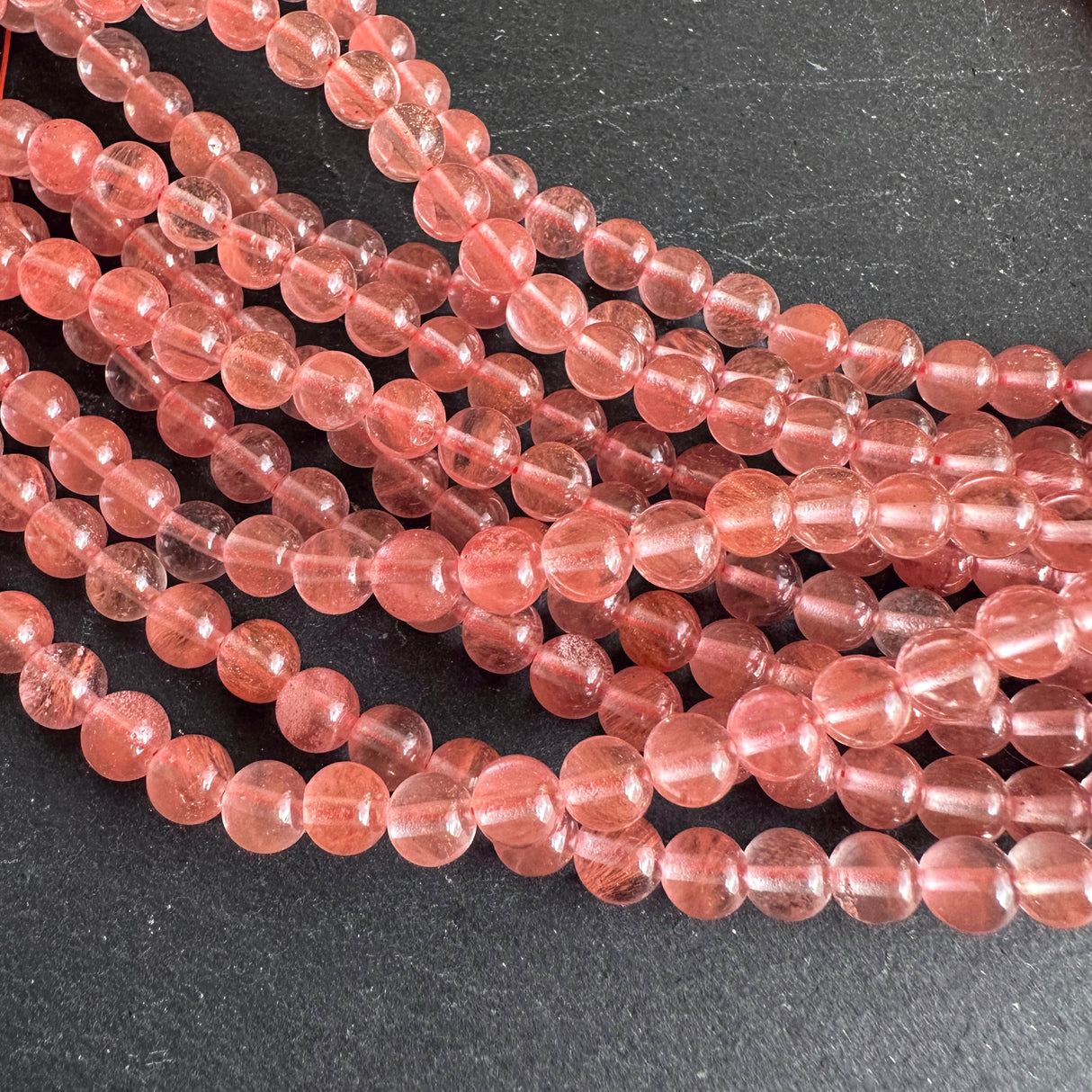 6mm cherry quartz beads (glass) - round - smooth - 15" strand - approx. 65 beads