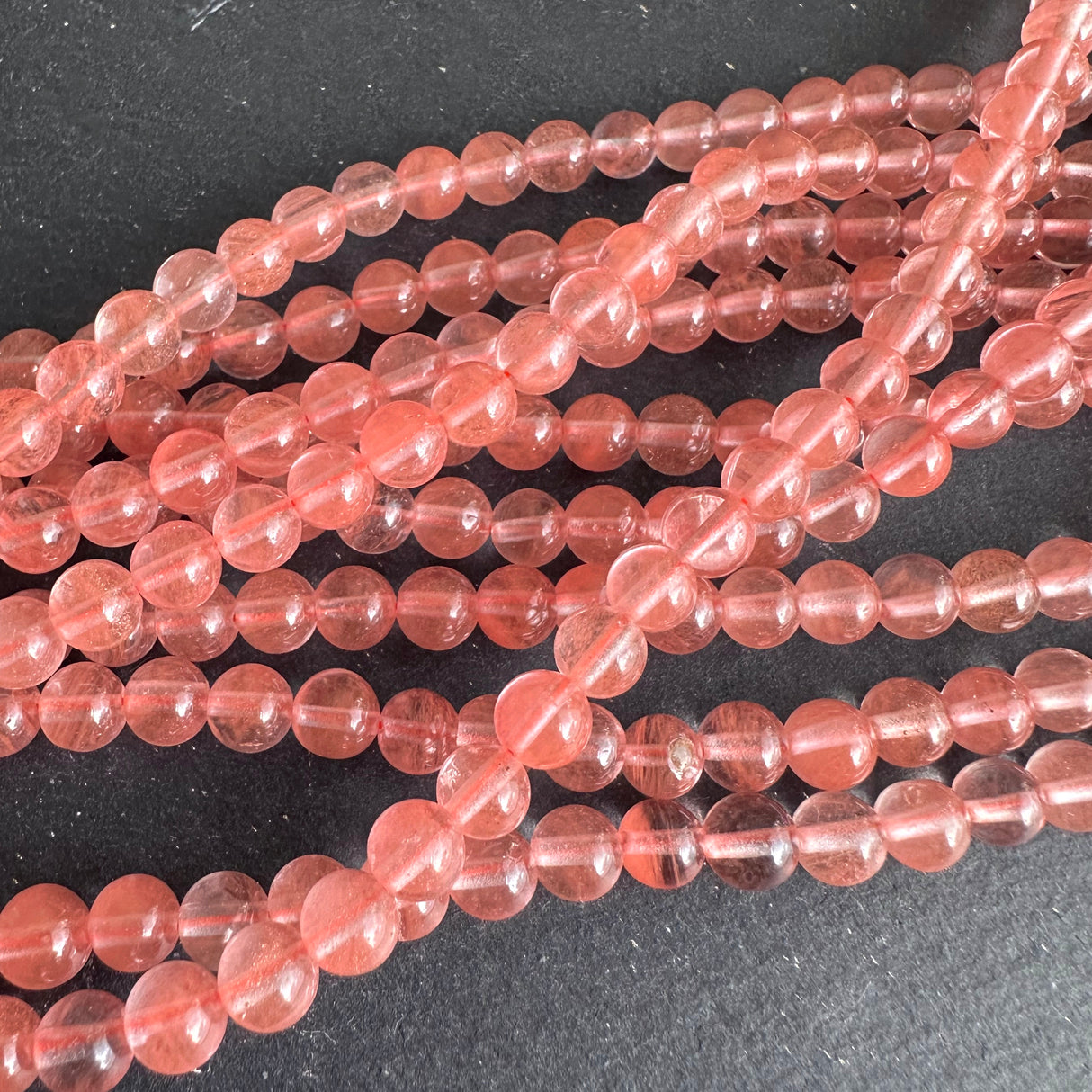 6mm cherry quartz beads (glass) - round - smooth - 15" strand - approx. 65 beads