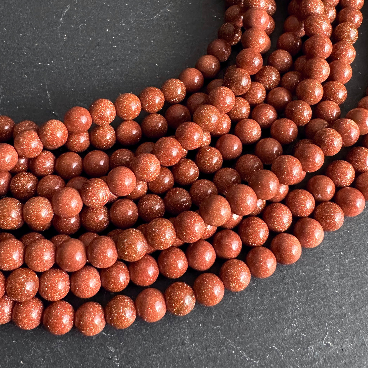 6mm goldstone beads (glass) - round - smooth - 15" strand - approx. 65 beads