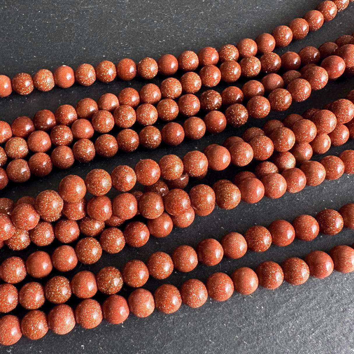 6mm goldstone beads (glass) - round - smooth - 15" strand - approx. 65 beads