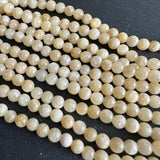 6mm yellow jade beads (undyed) - round- smooth - 15" strand - approx. 65 beads