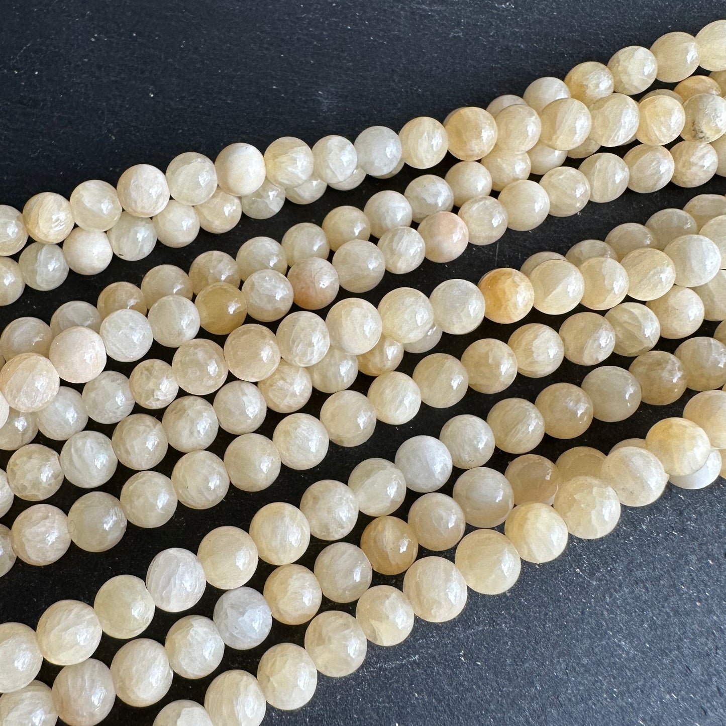 6mm yellow jade beads (undyed) - round- smooth - 15" strand - approx. 65 beads