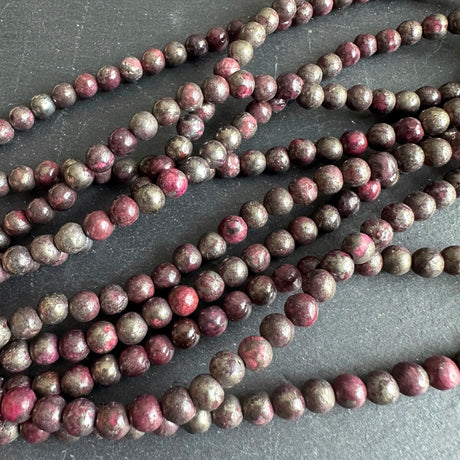 6mm pink pyrite stone beads - round - smooth - 15" strand - approx. 65 beads