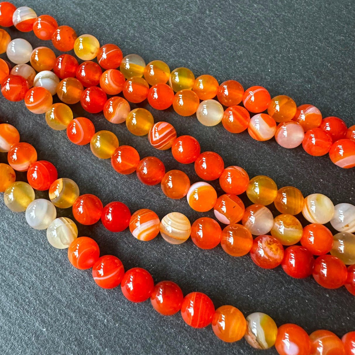 6mm orange striped agate beads - round - smooth - 15" strand - approx. 60 beads