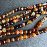 6mm golden brown striped agate beads - round - smooth - 15" strand - approx. 60 beads