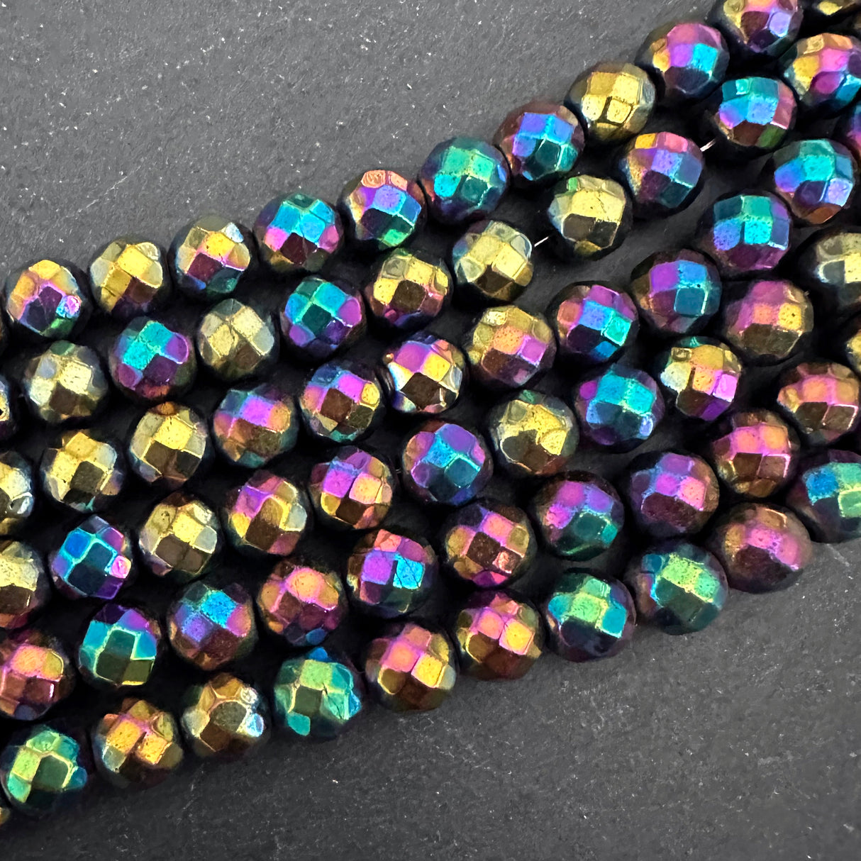 8mm rainbow electroplated hematite - round - faceted - 16" strand - approx. 50 beads