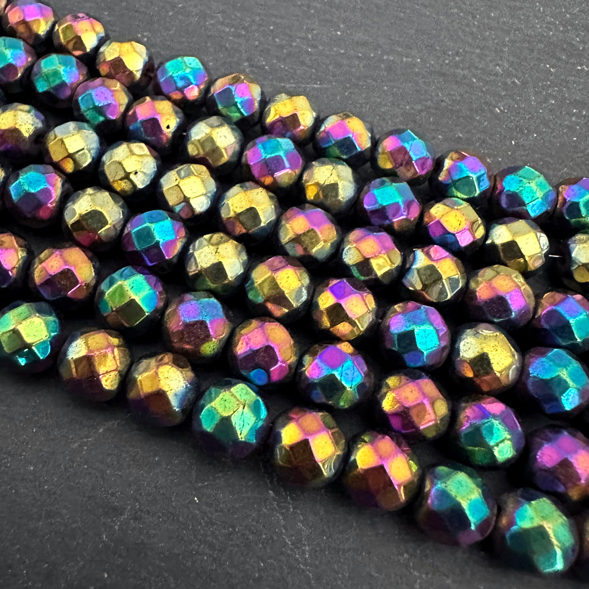 8mm rainbow electroplated hematite - round - faceted - 16" strand - approx. 50 beads