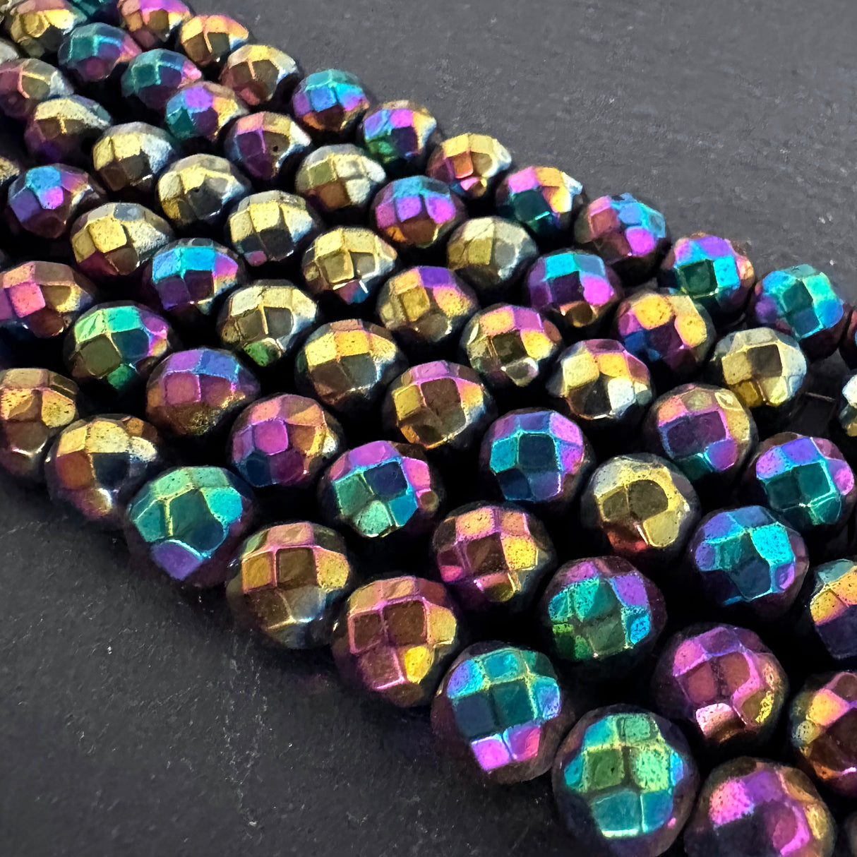 8mm rainbow electroplated hematite - round - faceted - 16" strand - approx. 50 beads