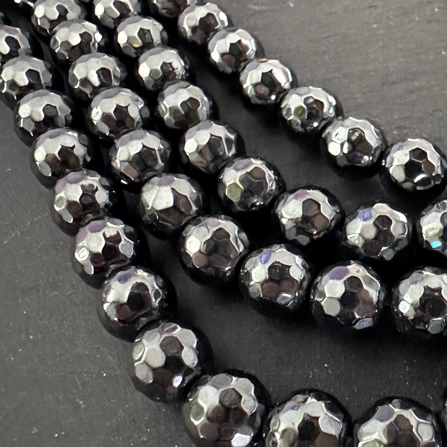 8mm black electroplated hematite - round - faceted - 16" strand - approx. 50 beads