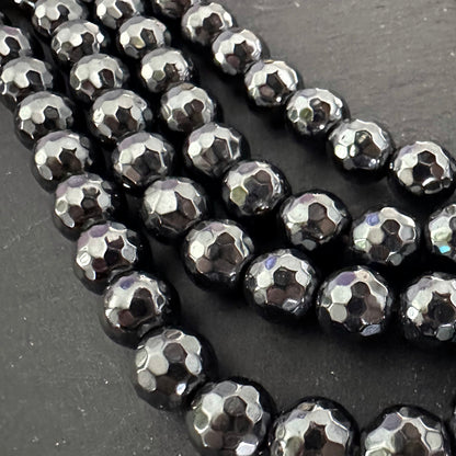 8mm black electroplated hematite - round - faceted - 16" strand - approx. 50 beads