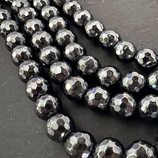 8mm black electroplated hematite - round - faceted - 16" strand - approx. 50 beads