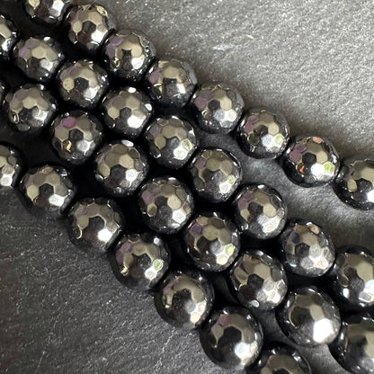 8mm black electroplated hematite - round - faceted - 16" strand - approx. 50 beads