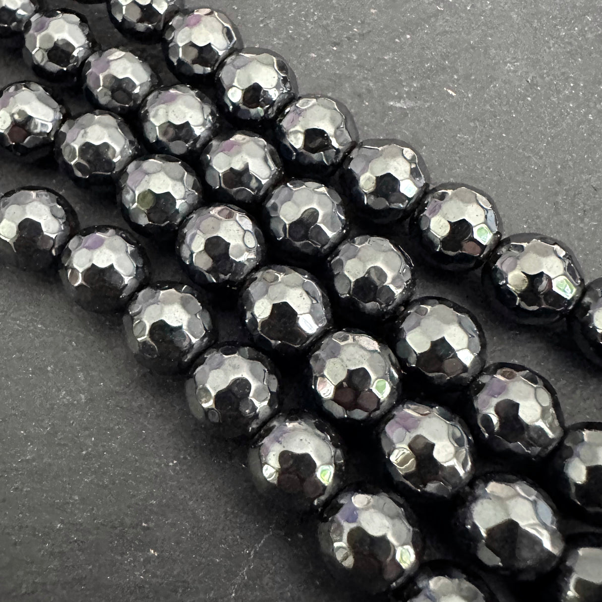 8mm black electroplated hematite - round - faceted - 16" strand - approx. 50 beads