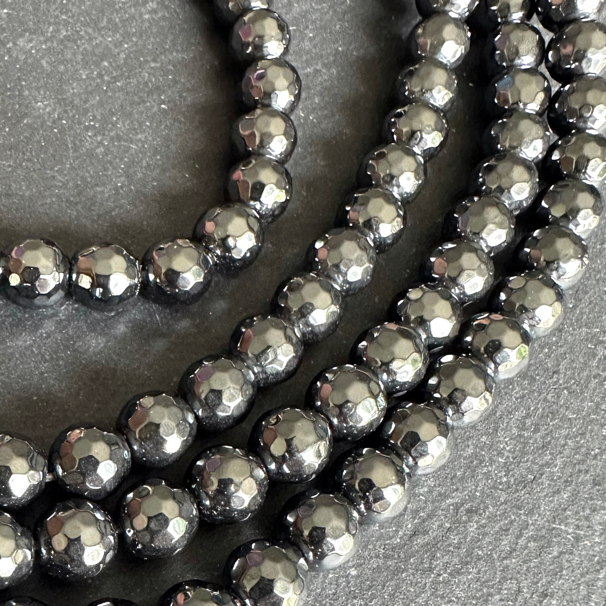 8mm black electroplated hematite - round - faceted - 16" strand - approx. 50 beads